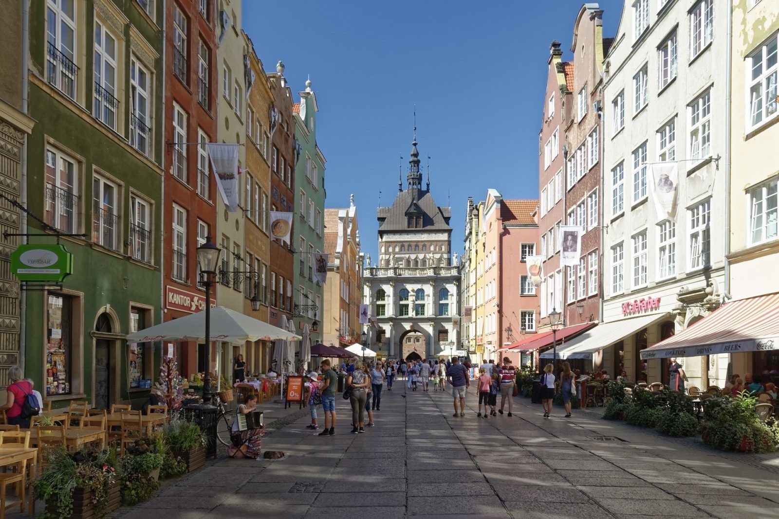 traditional walking street in gdansk medieval old town lined with restaurants on a summer day