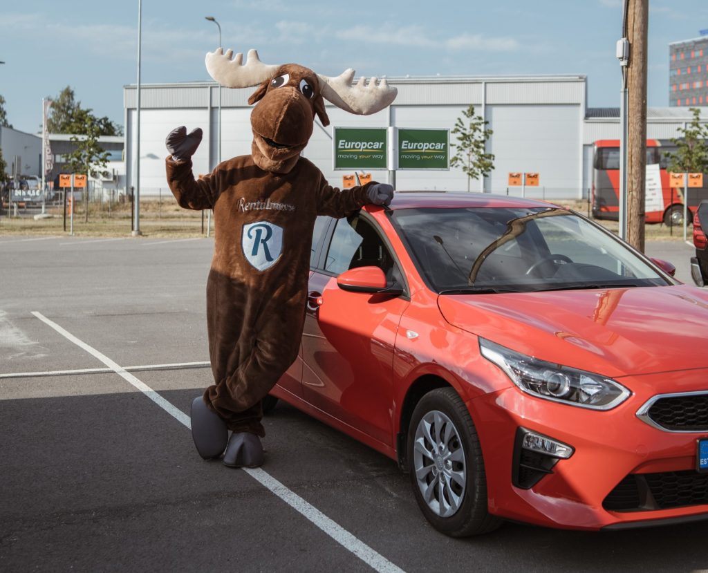 Rental Moose mascot posing with red Kia rental car. Europcar Estonia rental car fleet.