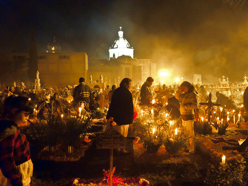 Cemetery full of people and illuminated by candles during the spectacular Day of The Dead Celebrations in Mixquic. Make sure you see these celebrations, perhaps on a day trip from Mexico City.