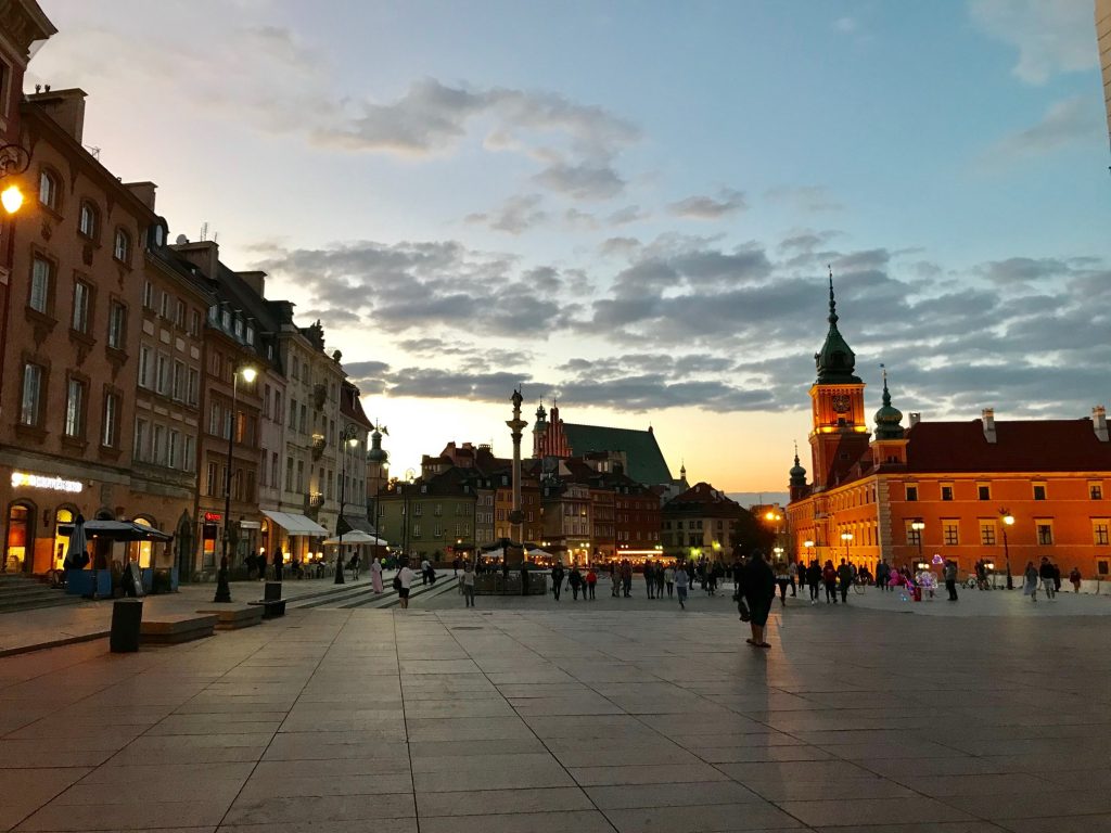 Warsaw Old Town, Zygmunt Column and The Royal Castle seen during sunset. See the best things to do in Warsaw with our curated travel guide