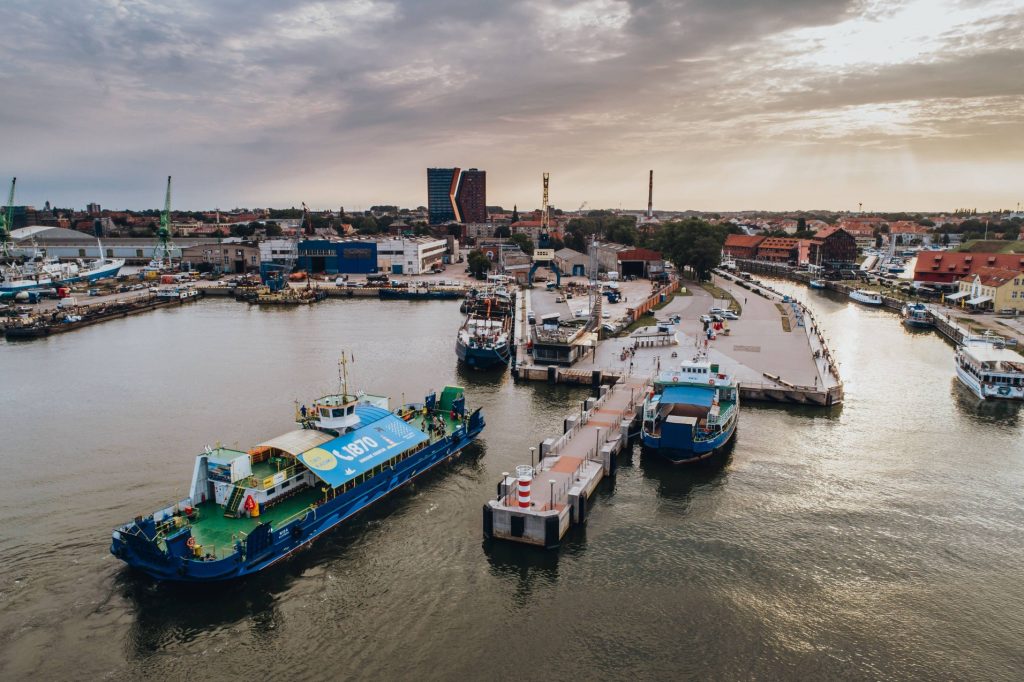 Klaipeda ferry service is the best way to get to the Curonian Spit. Ferry boat seen from above, leaving the old ferry port in the center of Klaipeda