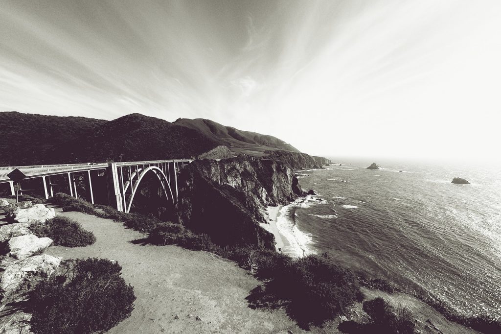 Bixby Creek Bridge in a black and white photo on a clear day in Big Sur, California.