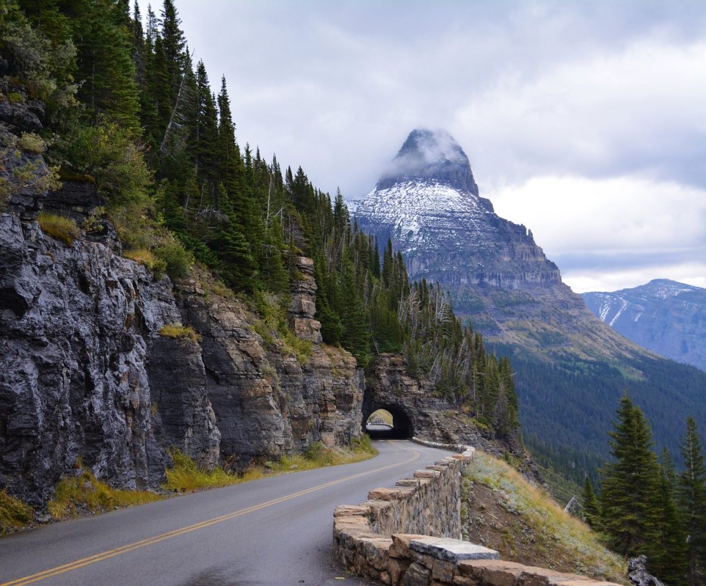 natural tunnel in a mountain road. Going to the sun road, in Glacier national Park in Montana, is considered to be one of the best driving roads in the world.