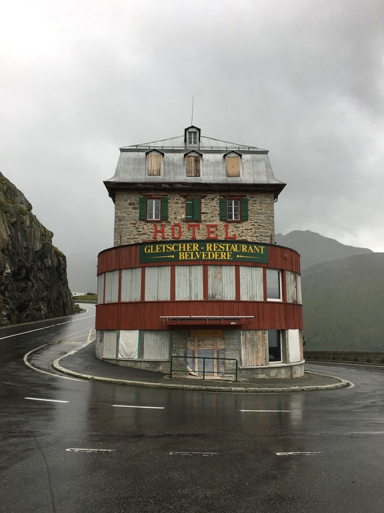 abandoned Belvedere Hotel in Furka Pass, Switzerland. The hotel located at a hairpin turn is an eerie photo opportunity for those who drive down Furka.