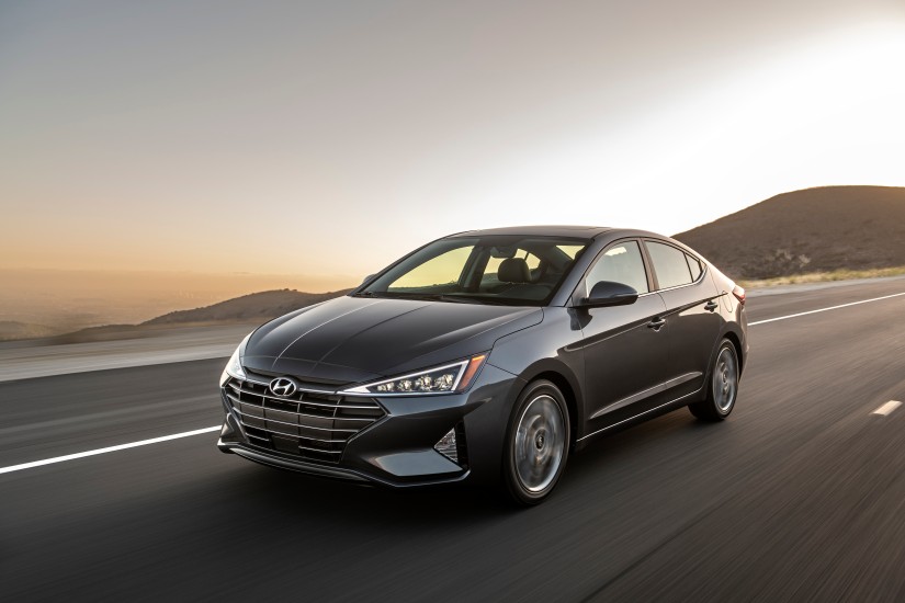 2020 Hyundai Elantra, an intermediate rental car, driving off into the sunset. 