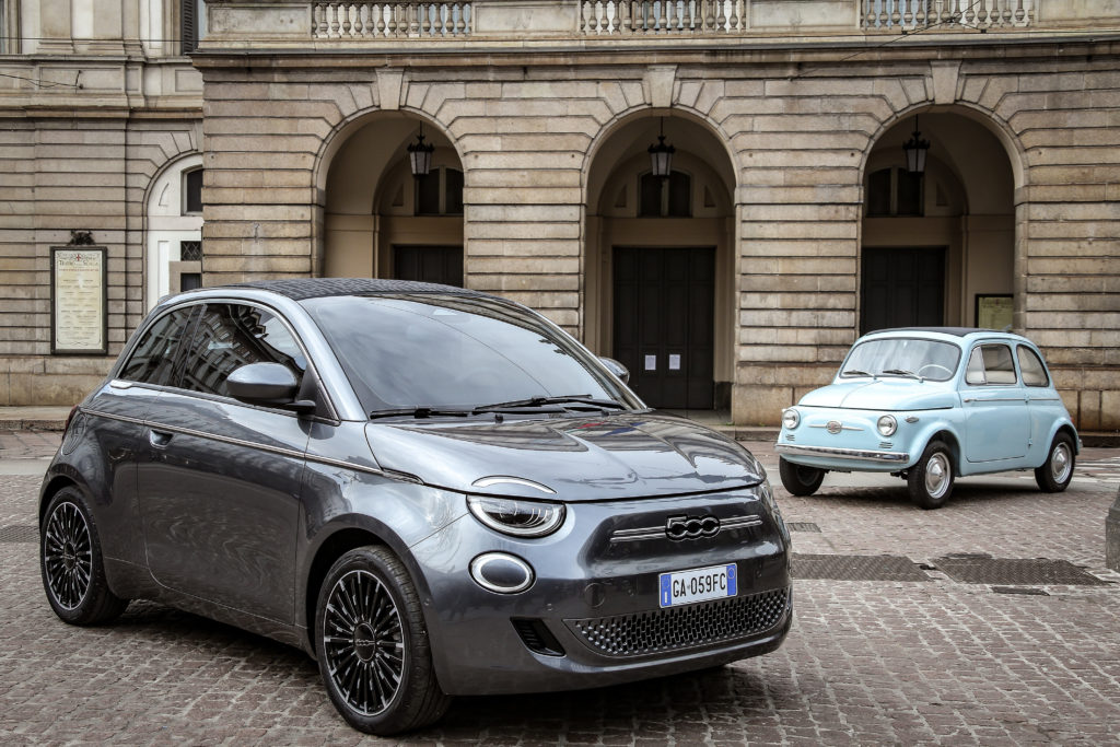 Electric Fiat 500e parked next to vintage Fiat 500 shows the future of mobility, as well as paying homage to classic motoring.