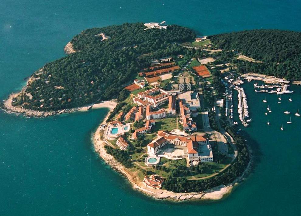 Brioni is a pebble beach in Croatia. Aerial view of the resort town and beach.