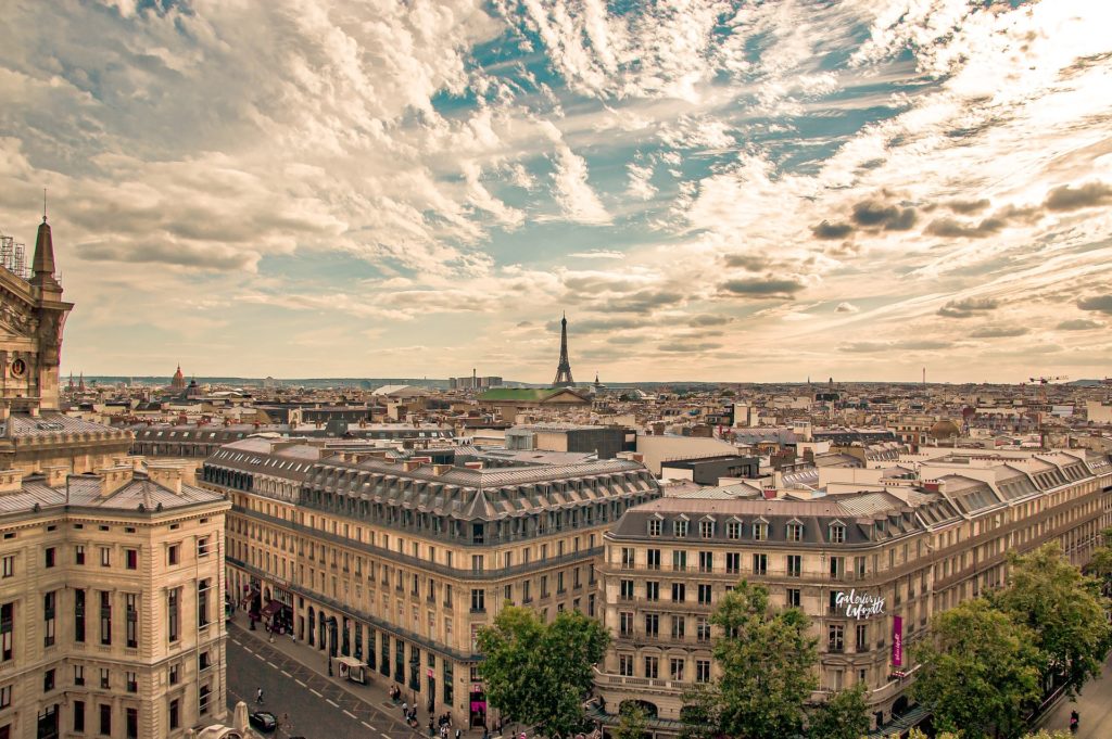 the skyline of Paris seen on a sunny day. Our insightful guide will help you navigate around rental car insurance in France.